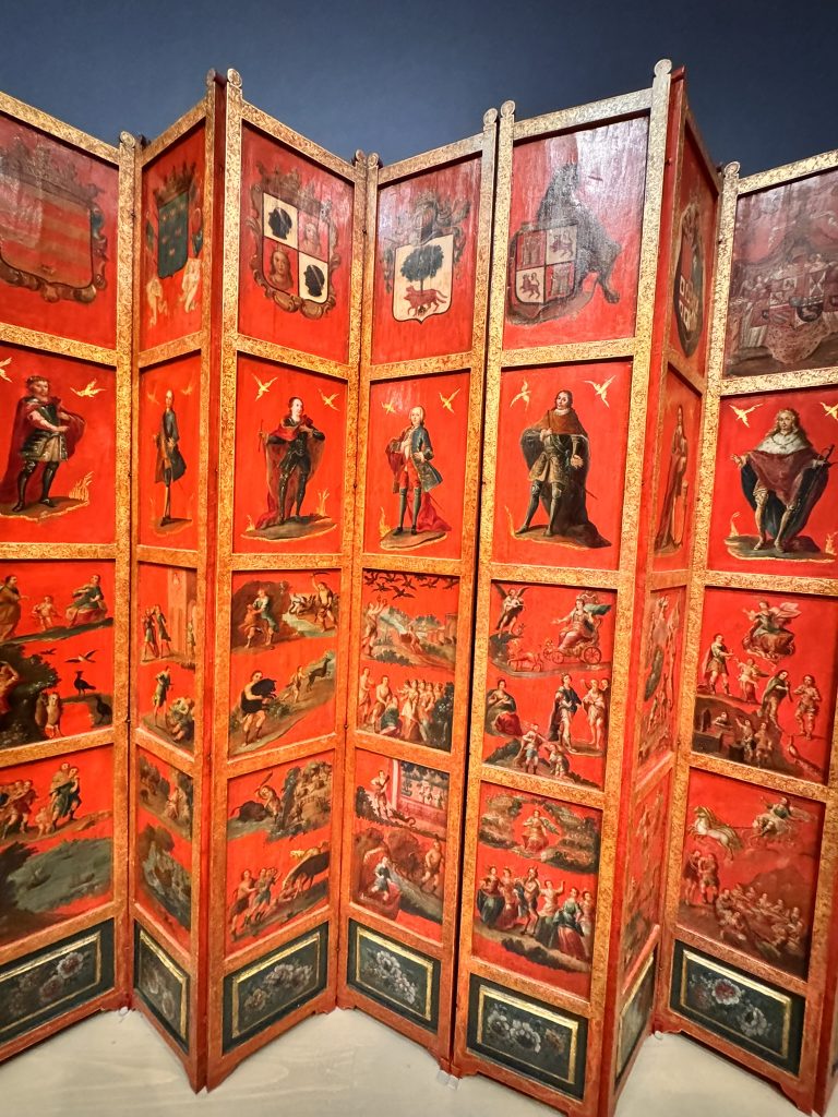 Chinese lacquer screen, about 1700. European visitors appear amid mountains, flowers, and other elements of a Chinese visual world.